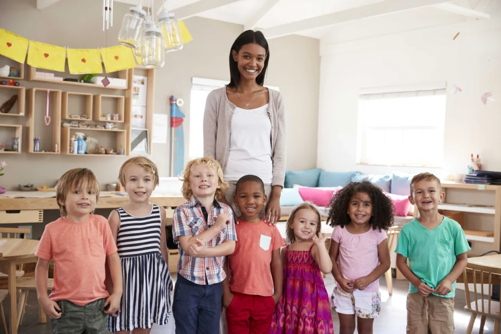 teacher and 7 kids smiling